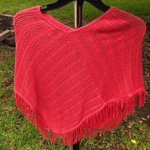 Pink poncho, cotton stitching across.